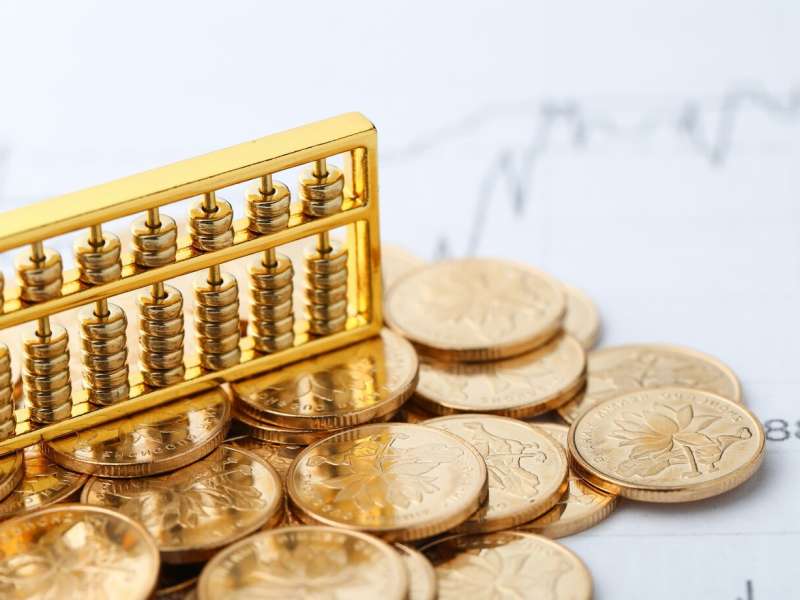 golden-abacus-with-chinese-rmb-gold-coins-as-background_1387-145